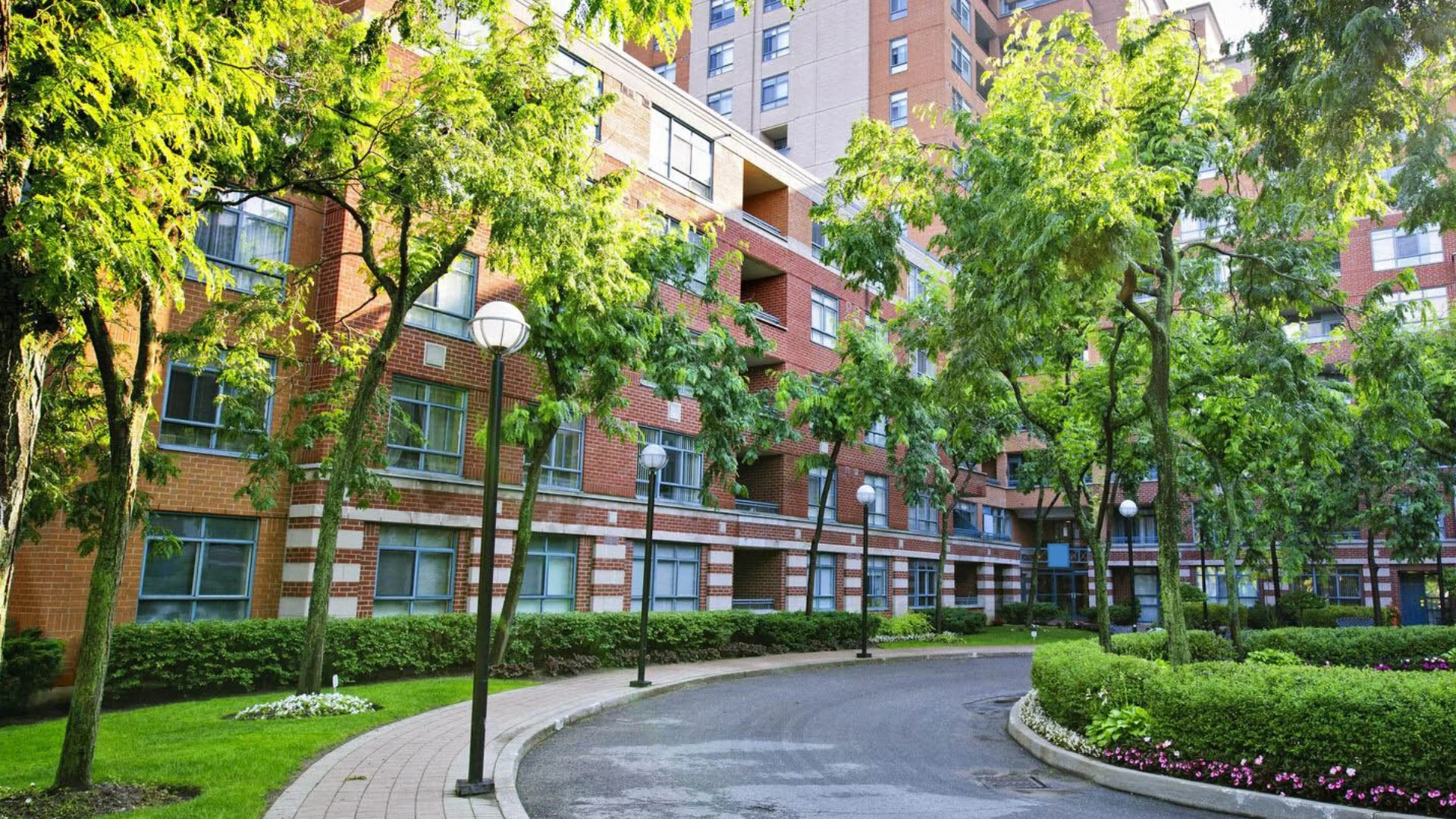 Commercial brick building with trees on foreground
