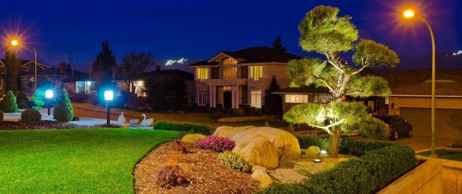 Front yard in Longmont, CO, with shrubs and outdoor lighting.