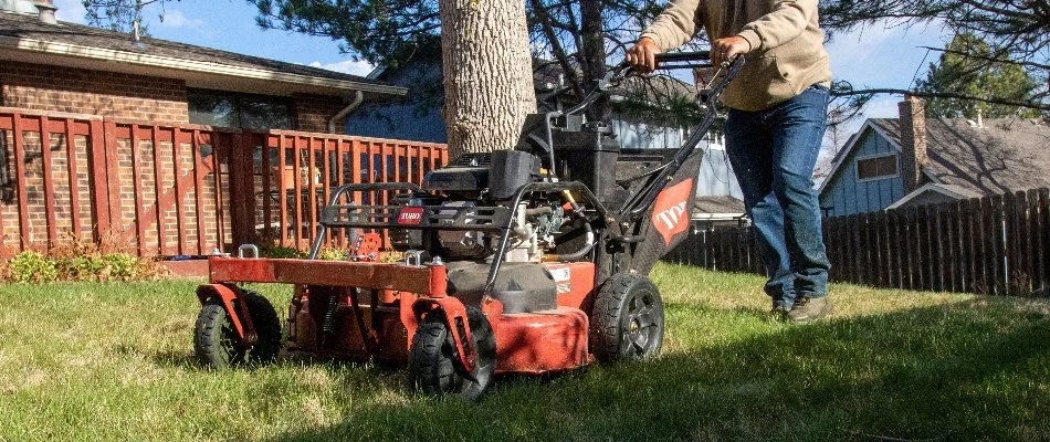 Man mowing a lawn in Longmont, CO.